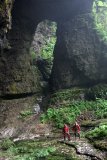 A rock window at the bottom of a huge doline near the unexplored Boniukeng Cave.