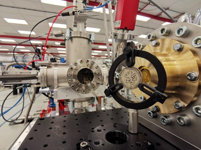  In-air non-destructive testing of a coin by laser-accelerated proton beams